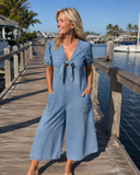 Mischa wide-leg denim jumpsuit with tie-front V-neck and puff sleeves