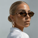 Sorrento small oval sunglasses with a tortoiseshell frame and brown lenses, view 4