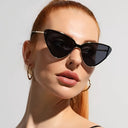 Tulum cat eye sunglasses with a gold metal frame and tinted lenses, view 5