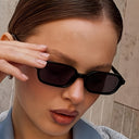 Mykonos small rectangle sunglasses with a black frame and dark lenses, view 2