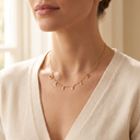 Woman wearing a gold name necklace spelling OLIVIA