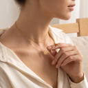 Gold name necklace layered with a fine gold chain