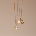 Una Initial Letter and Baroque Pearl Necklace