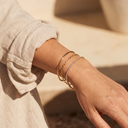 Woman wearing gold bracelets and bangle – Marliva