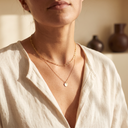 Woman wearing layered gold necklaces – Marliva